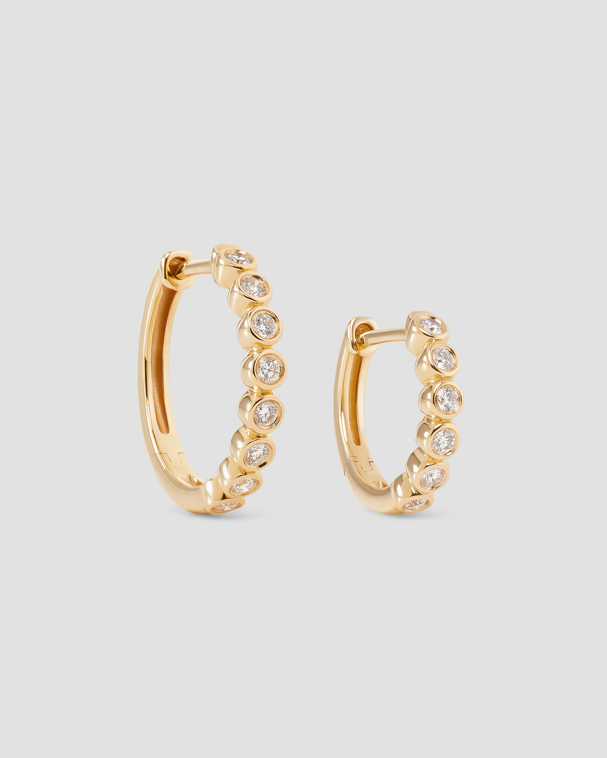 Essential Round Diamond Bezel Huggie gold earring - alternate angle | diamond huggie earrings