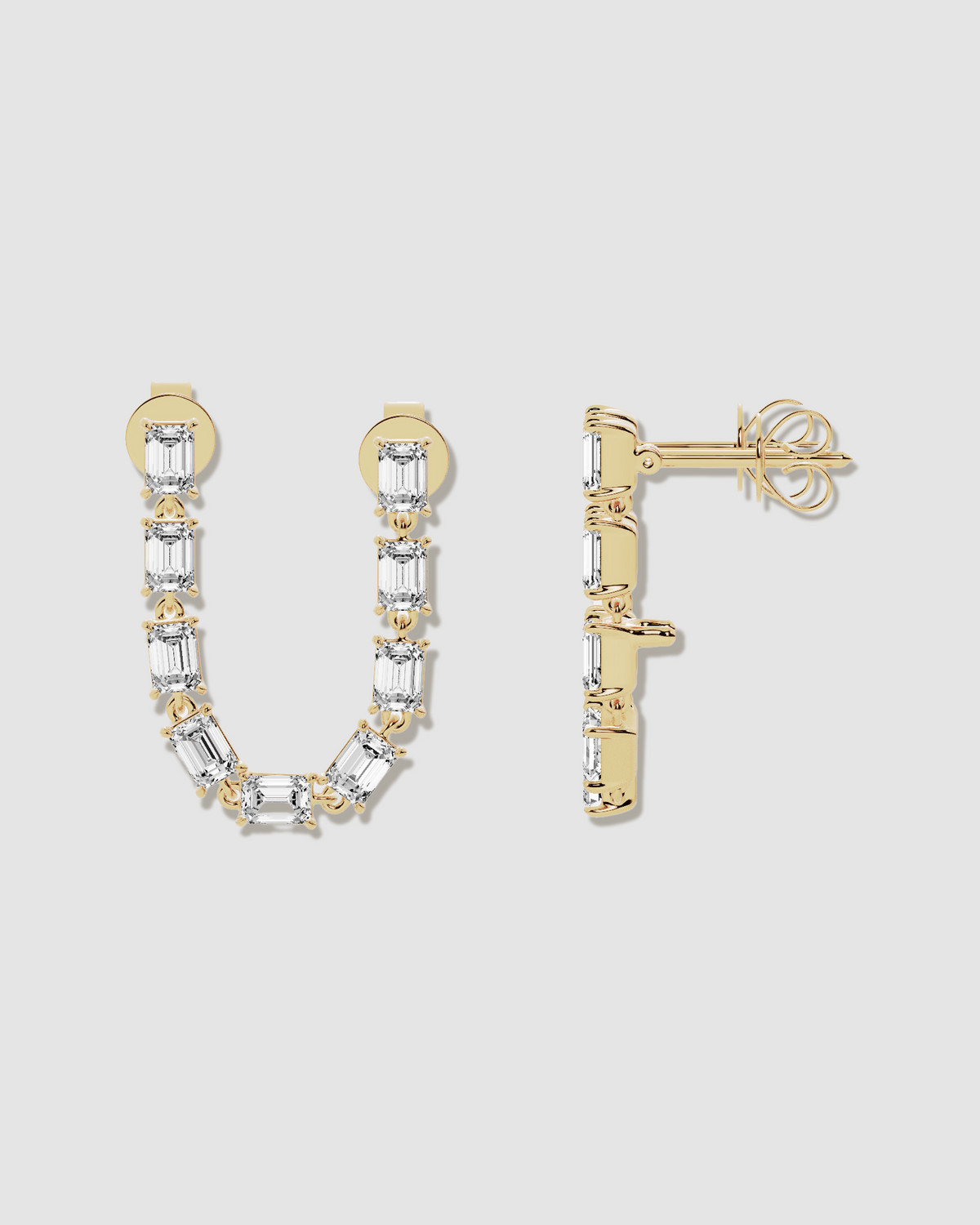 Diamond earrings on grey background - one rotated to the left