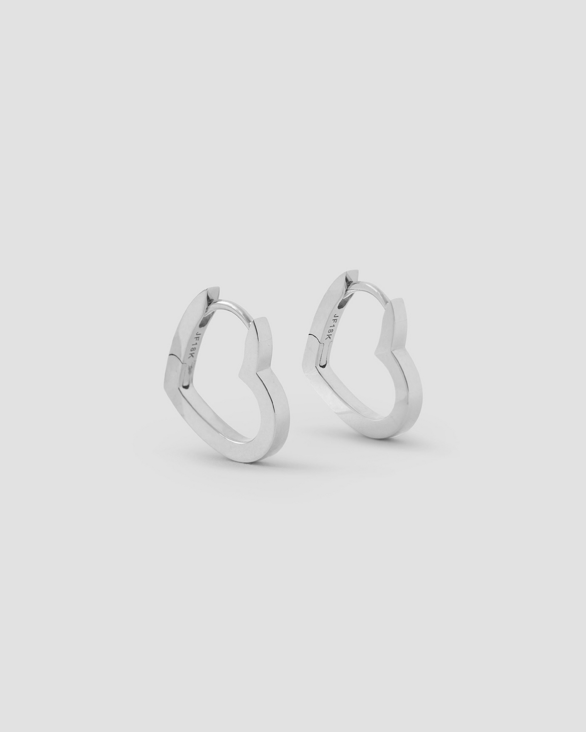 18k Small Heart Huggie earring - product detail shot | gold huggie earrings