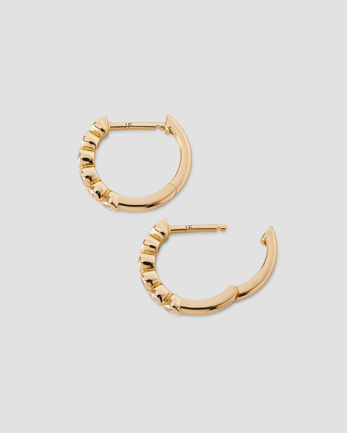 Essential Round Diamond Bezel Huggie gold earring - product detail shot | diamond huggie earrings