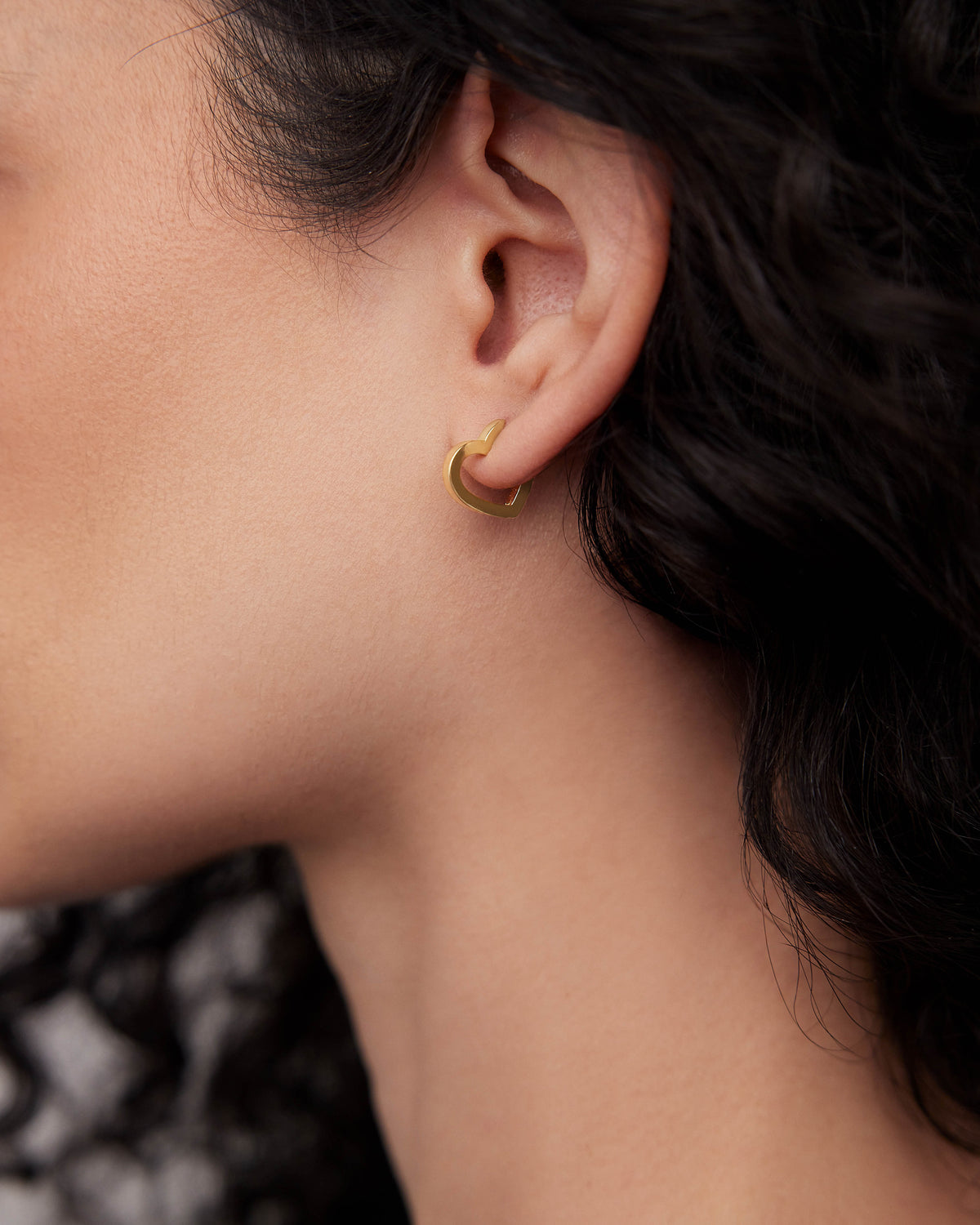 18k Small Heart Huggie earring - alternate angle | gold huggie earrings