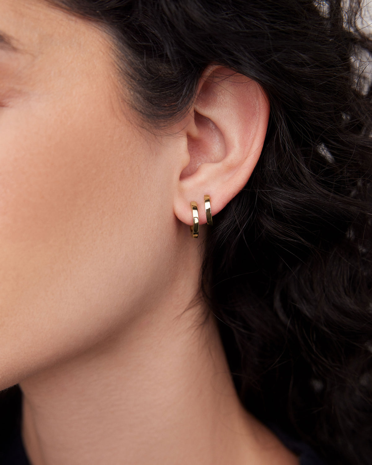 18k Extra Small Huggie earring - alternate angle | gold huggie earrings